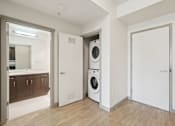 Thumbnail 13 of 43 - A laundry room with a washer and dryer.