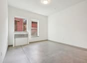 Thumbnail 30 of 43 - Empty room with a window and a radiator.
