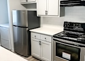 Thumbnail 12 of 17 - A modern kitchen with stainless steel appliances and white cabinets.