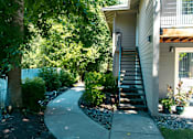 Thumbnail 5 of 17 - A house with a staircase leading to the front door.