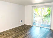 Thumbnail 17 of 17 - A room with a sliding glass door leading to a balcony.