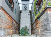 Thumbnail 9 of 11 - the clock tower in the middle of a alley between two buildings