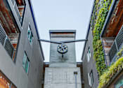 Thumbnail 2 of 11 - a clock tower on the side of a building