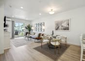 Thumbnail 7 of 42 - an open living room and dining room with a table and chairs
