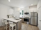 Thumbnail 5 of 42 - a kitchen with a large island and stainless steel appliances