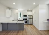 Thumbnail 26 of 42 - a kitchen with white cabinets and stainless steel appliances