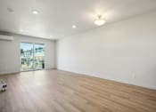 Thumbnail 27 of 42 - the living room is spacious and has a large window and hardwood flooring
