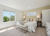 Thumbnail 12 of 42 - a bedroom with a bed and two windows