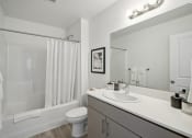Thumbnail 18 of 42 - a bathroom with a large mirror and a shower and a toilet