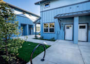 Thumbnail 19 of 55 - A blue building with white doors and windows.