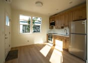 Thumbnail 24 of 55 - A kitchen with wooden cabinets and a stainless steel refrigerator.