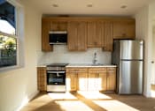 Thumbnail 26 of 55 - A kitchen with wooden cabinets and stainless steel appliances.