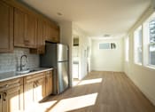 Thumbnail 29 of 55 - A kitchen with wooden cabinets and a stainless steel refrigerator.