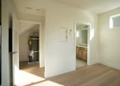 Thumbnail 34 of 55 - A room with a white door and a white wall.