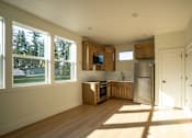 Thumbnail 37 of 55 - A kitchen with wooden cabinets and a stainless steel refrigerator.