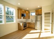 Thumbnail 42 of 55 - A modern kitchen with wooden cabinets and stainless steel appliances.