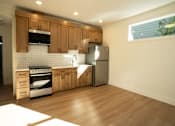 Thumbnail 45 of 55 - A kitchen with wooden cabinets and a stainless steel refrigerator.