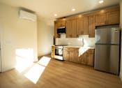 Thumbnail 46 of 55 - A kitchen with wooden cabinets and a stainless steel refrigerator.