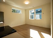 Thumbnail 47 of 55 - A sunny room with a black countertop and a window.