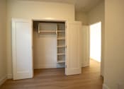Thumbnail 53 of 55 - A white door is open to a room with a shelving unit.