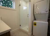 Thumbnail 51 of 55 - A bathroom with a toilet, sink, and shower.