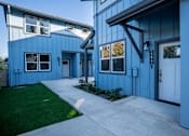 Thumbnail 4 of 55 - A blue house with a white door and windows.