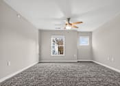 Thumbnail 20 of 30 - A room with a ceiling fan and a window.