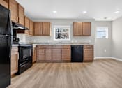 Thumbnail 14 of 30 - A kitchen with wooden cabinets and black appliances.