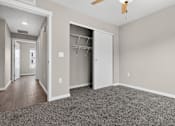 Thumbnail 17 of 30 - A room with a ceiling fan and a closet with shelves.
