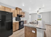 Thumbnail 10 of 30 - A kitchen with black appliances and wooden cabinets.