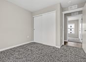Thumbnail 16 of 30 - A room with a grey carpet and a white door.