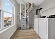 Thumbnail 28 of 30 - A kitchen with white appliances and a window overlooking a parking lot.