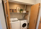 Thumbnail 13 of 16 - A laundry room with a washer and dryer in it.