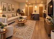 Thumbnail 4 of 16 - A modern living room with a white sofa, wooden coffee table, and a TV on the wall.
