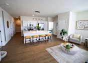 Thumbnail 5 of 22 - A kitchen with a white countertop and wooden floors.