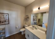 Thumbnail 8 of 22 - a bathroom with a sink and a toilet and a mirror at The Daniels at Northern Gateway Apartments, WI