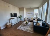 Thumbnail 5 of 22 - a living room with a leather couch and a tv at The Daniels at Northern Gateway Apartments, WI