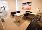 Thumbnail 13 of 22 - A room with a desk and chairs.