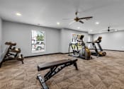 Thumbnail 9 of 30 - A spacious gym with a variety of equipment including treadmills, stationary bikes, and weight benches.