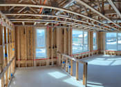 Thumbnail 7 of 16 - A room under construction with wooden beams and unfinished walls.
