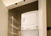 Thumbnail 16 of 30 - A white dishwasher is built into a wall in a kitchen.