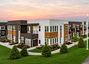 Thumbnail 1 of 30 - A modern apartment complex with a mix of brown and white exterior colors.