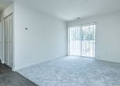 Thumbnail 22 of 37 - A room with white walls and a window with blinds.