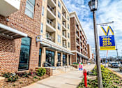 Thumbnail 4 of 26 - an apartment building with a yard sale sign in front of it