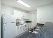 Thumbnail 13 of 37 - A kitchen with white appliances and cabinets.