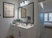 Thumbnail 27 of 40 - a white bathroom with a large mirror and a sink