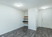 Thumbnail 30 of 37 - A room with a white door and a grey floor.