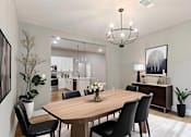 Thumbnail 43 of 53 - a dining room with a wooden table and chairs