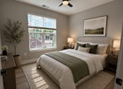 Thumbnail 7 of 11 - A bedroom with a large bed and a painting on the wall.