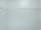 Thumbnail 28 of 37 - Empty white shelves in a room.